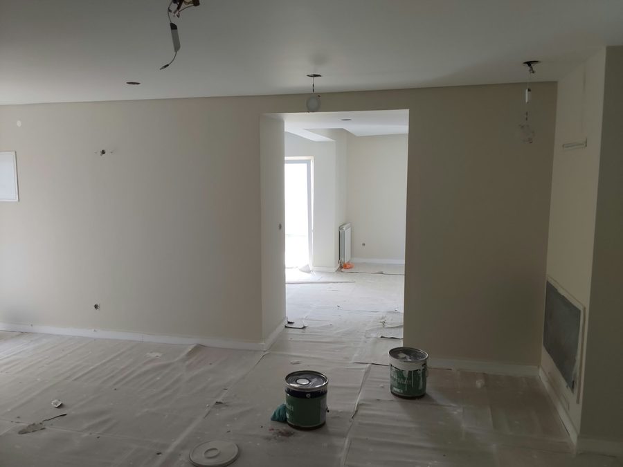 Room with the floor protected and paint tins, before painting